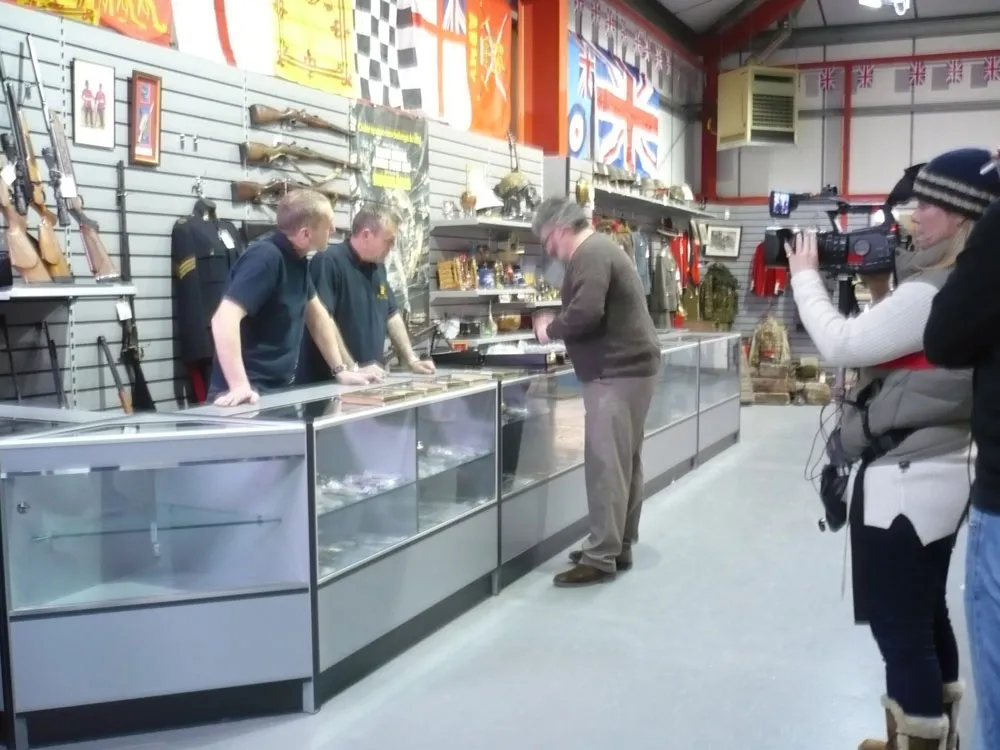 People at gun shop counter being filmed